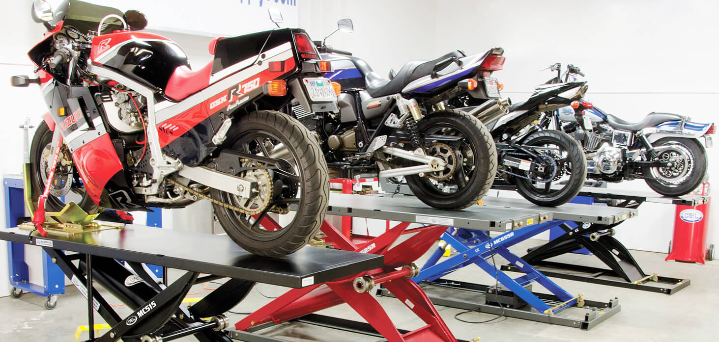 row of motorcyclees on lifts