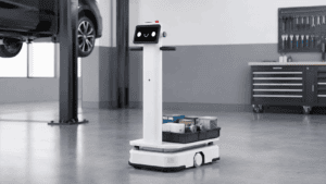 Image of White autonomous mobile robot carrying shop supplies in a modern service department